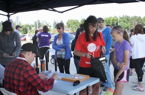 Becky Marsdin (L) and her daughter, McKenna, 12, of Walkerton register for the Gutsy Walk, Sunday morning at the Walkerton District Community School track